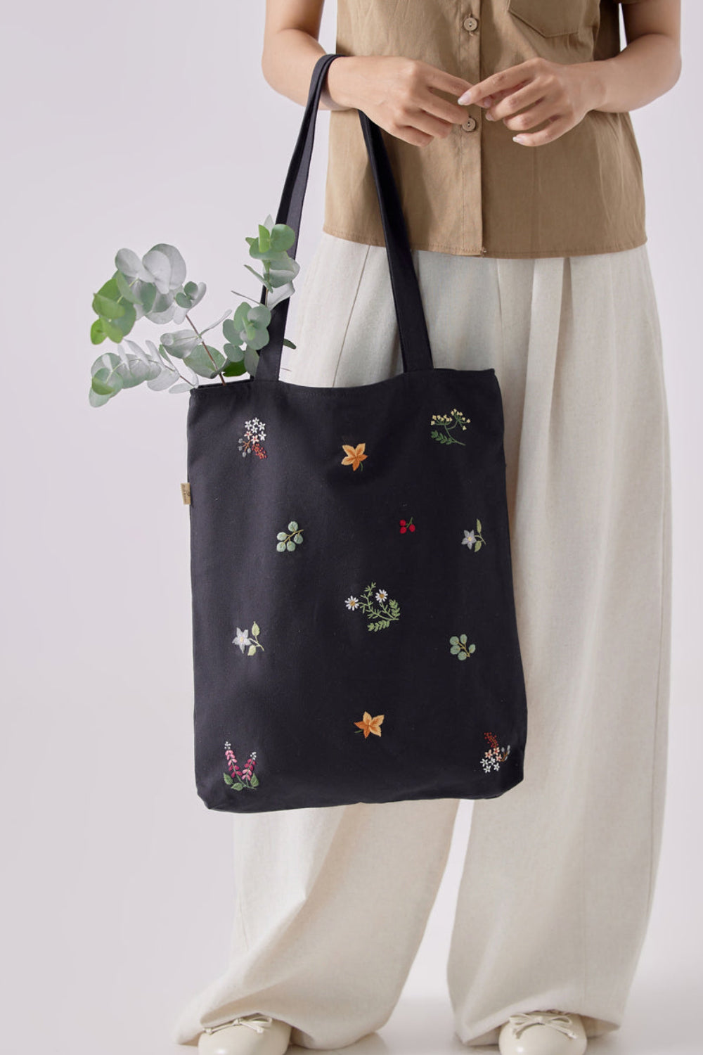 Floral Embroidery tote bag in black canvas with colorful stitched flowers, ideal for school, travel, or as a matron of honor gift.