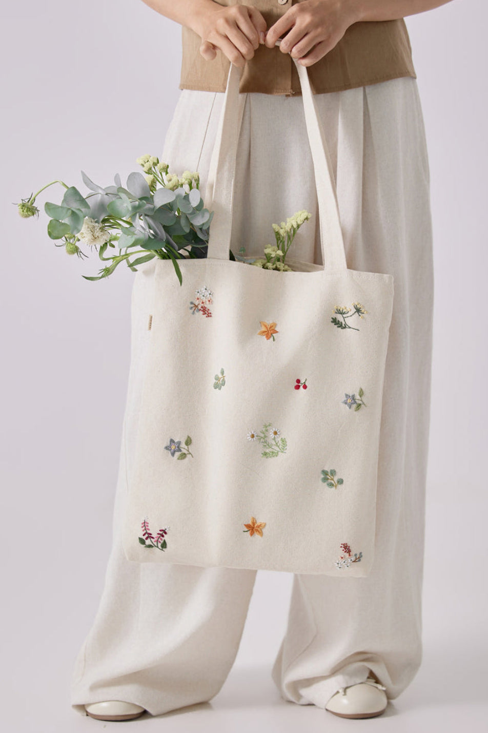 Floral Embroidery tote bag in beige canvas with colorful stitched flowers, ideal for school, travel, or as a matron of honor gift.