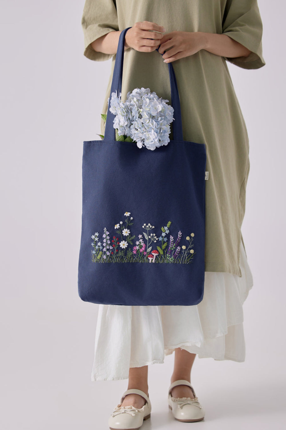 Navy blue Wildflowers Garden Embroidery Tote Bag featuring vibrant stitched flowers, perfect for spring fashion and daily accessories.