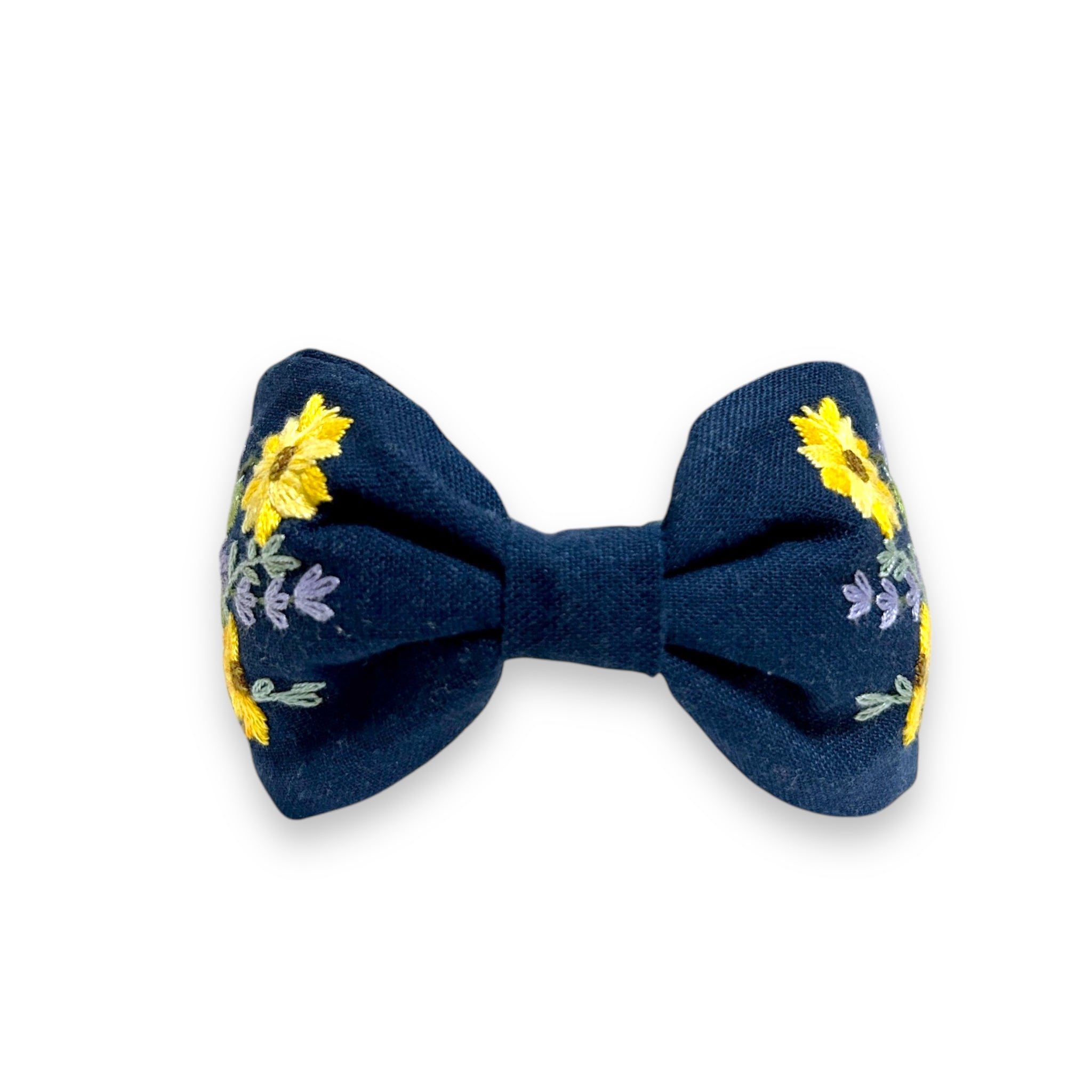 Back view of Emerald Field Blossom Embroidered Linen Headband by Rumoon Handmade, styled in a bow with floral embroidery on both sides.