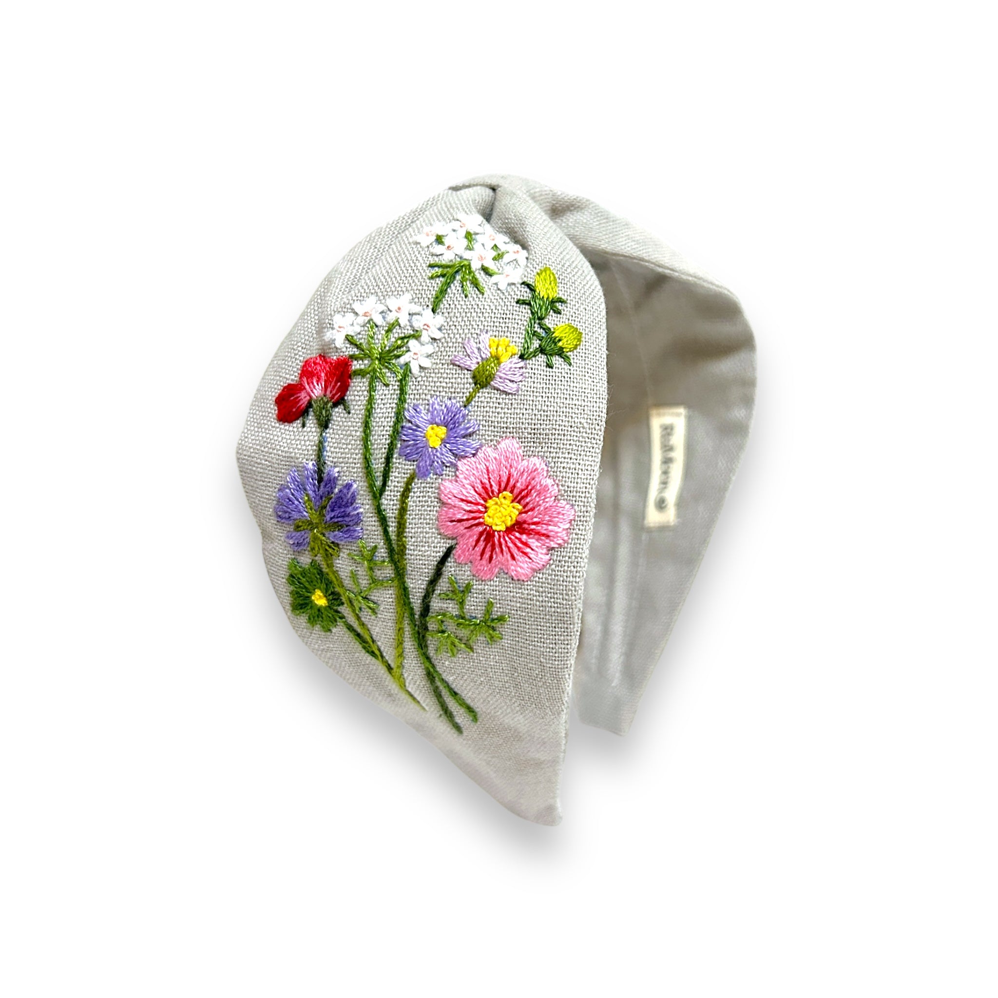 Eggshell Garden Floral Embroidered Linen Headband by Rumoon Handmade featuring colorful wildflower embroidery on soft grey fabric.