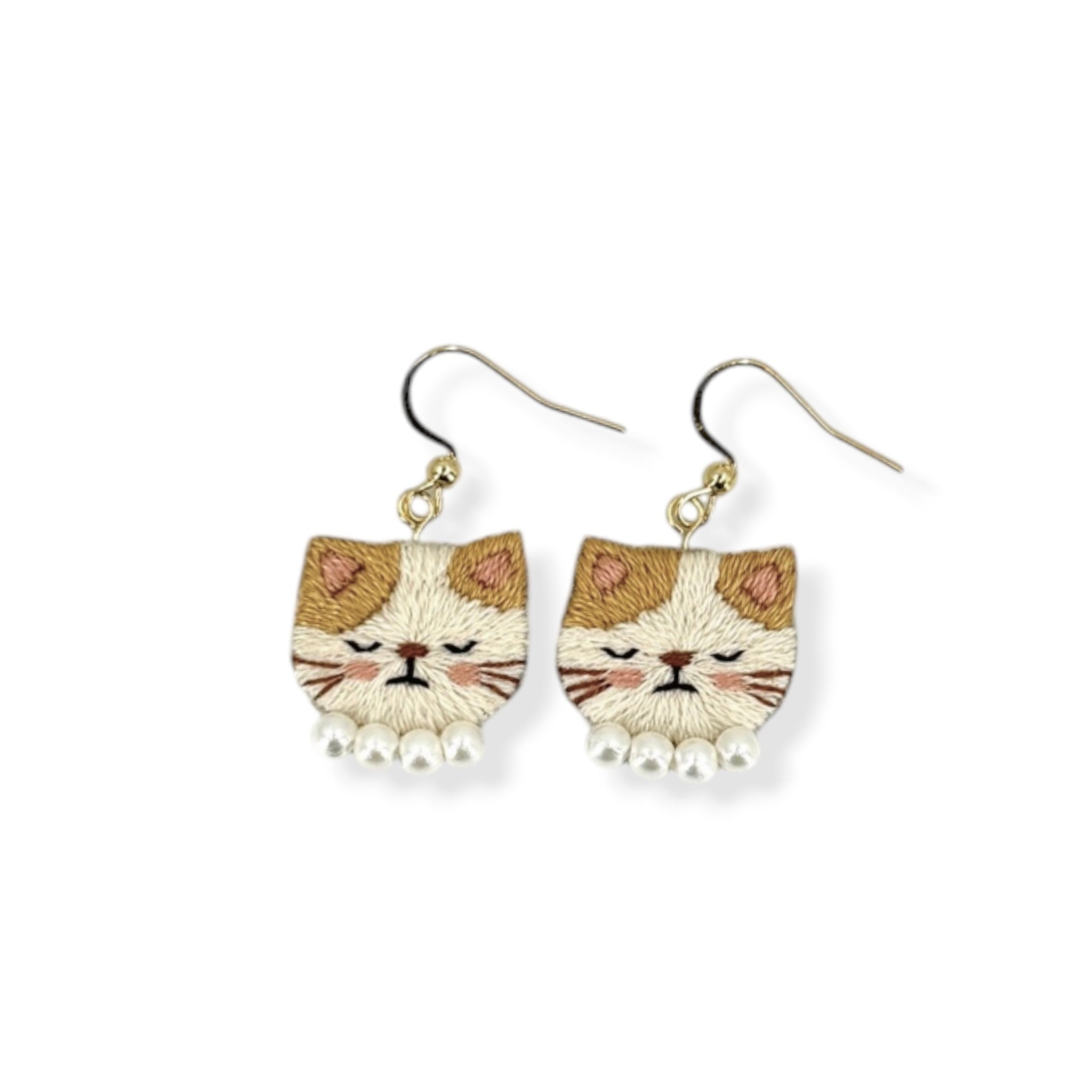 Cat-shaped earrings on a white background